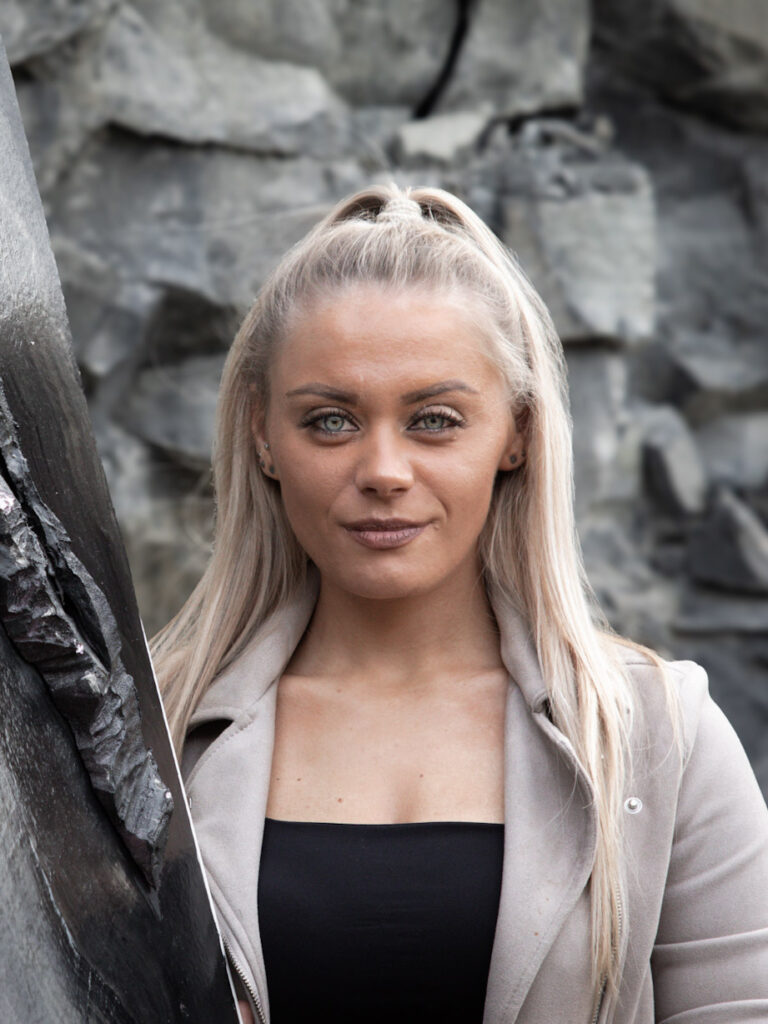 Ein Portrait der Künstlerin Jennit (Jenny Ulbl) in einem Steinbruch in ihren Corporate Colors anthrazit und taupe